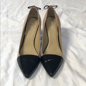 Nude pumps with black snakeskin toes